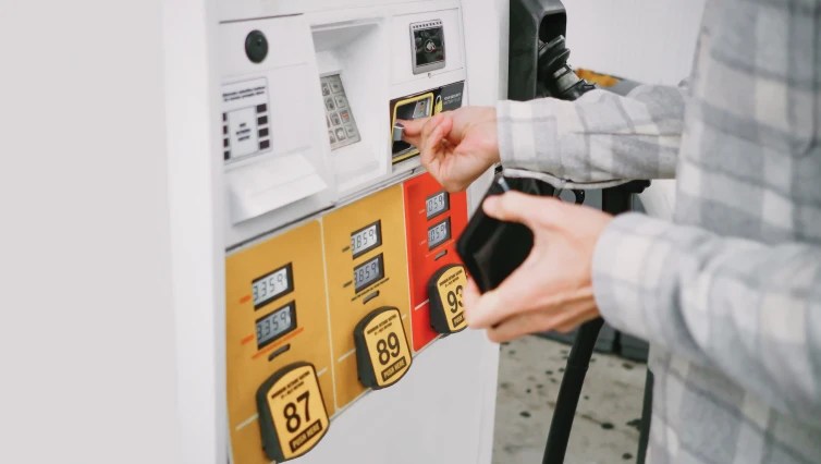 person at fuel pump inserting fuel card