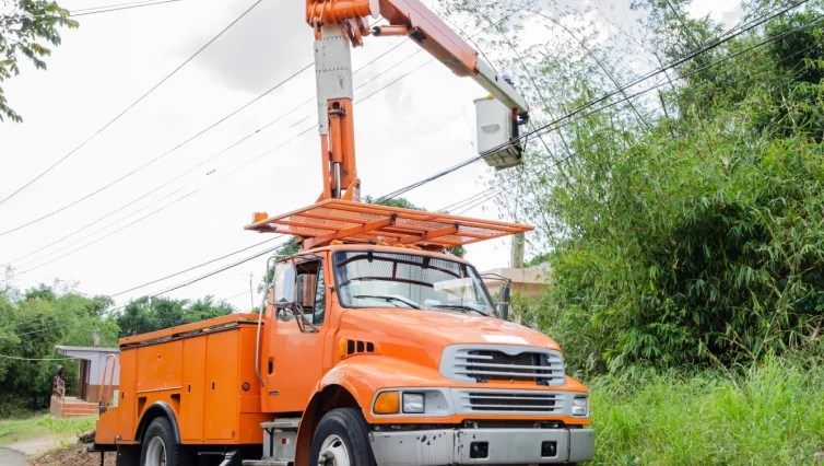 orange bucket truck servicing power line