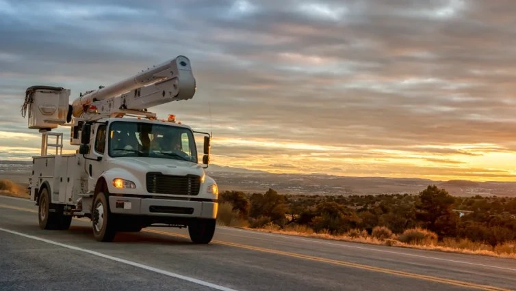 white bucket utility truck driving