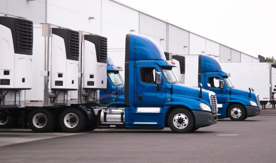 blue trucks and trailers at loading dock