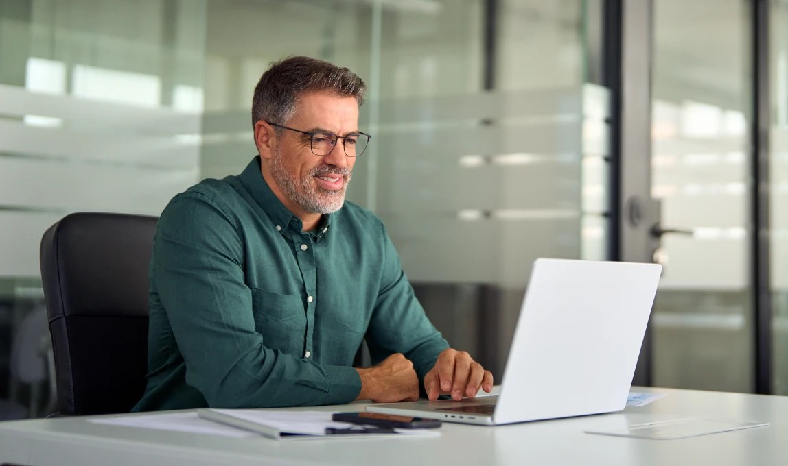 financial analyst reviewing data on laptop