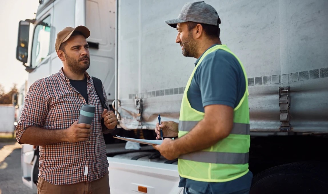 operations leader with driver reviewing trip