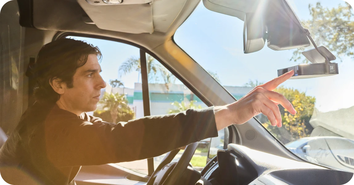 Vehicle driver turning on Motive's AI Dashcam Plus (AIDC+) to record video.