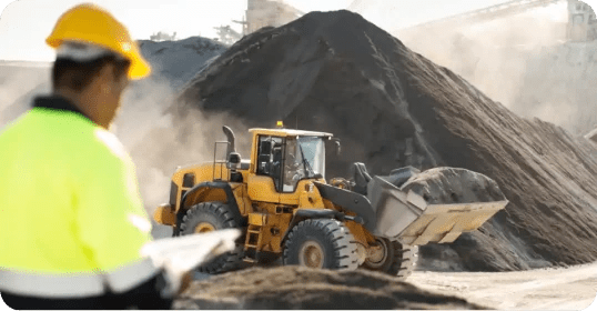 construction worker monitoring a wheel loader at a construction site