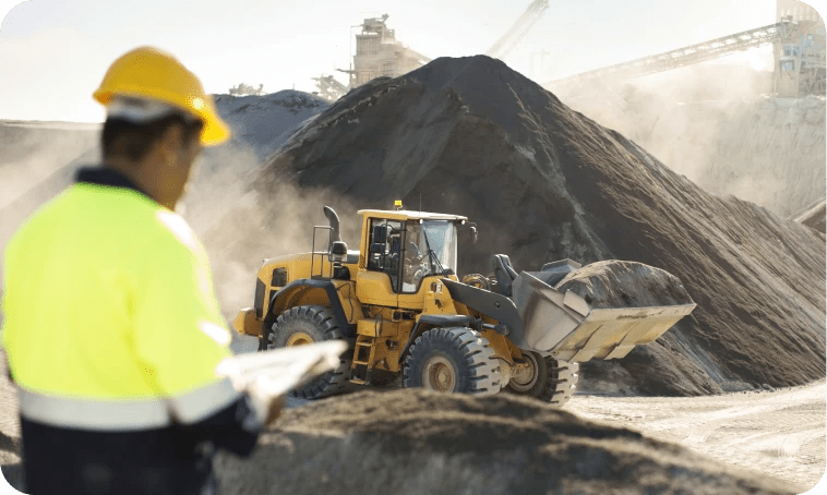 construction worker monitoring a wheel loader at a construction site