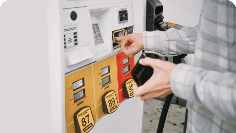 person inserting credit card at fuel pump