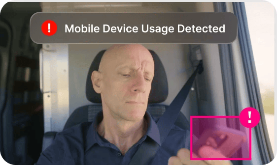 driver looking at phone with Mobile Device Usage Detected alert