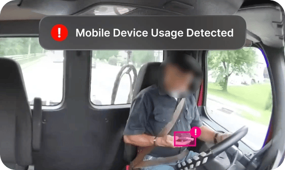 driver looking at phone with Mobile Device Usage Detected alert