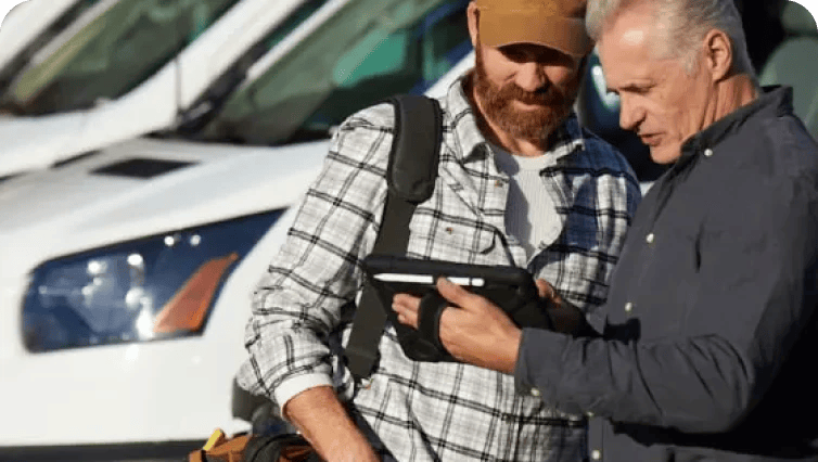 driver and fleet owner looking at information on a tablet
